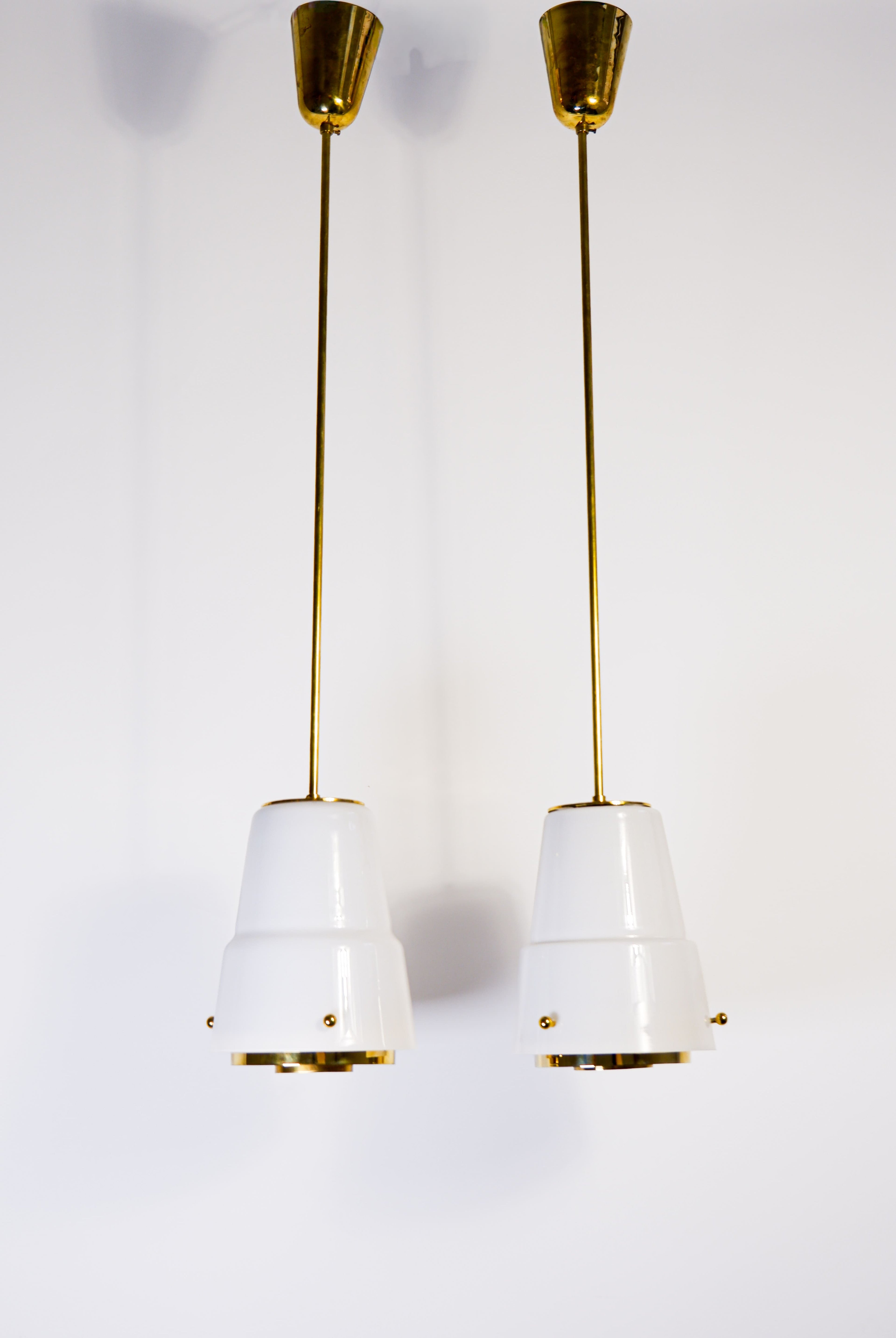 Paavo Tynell, pair of pendant in opal & brass, Idman circa 1940.