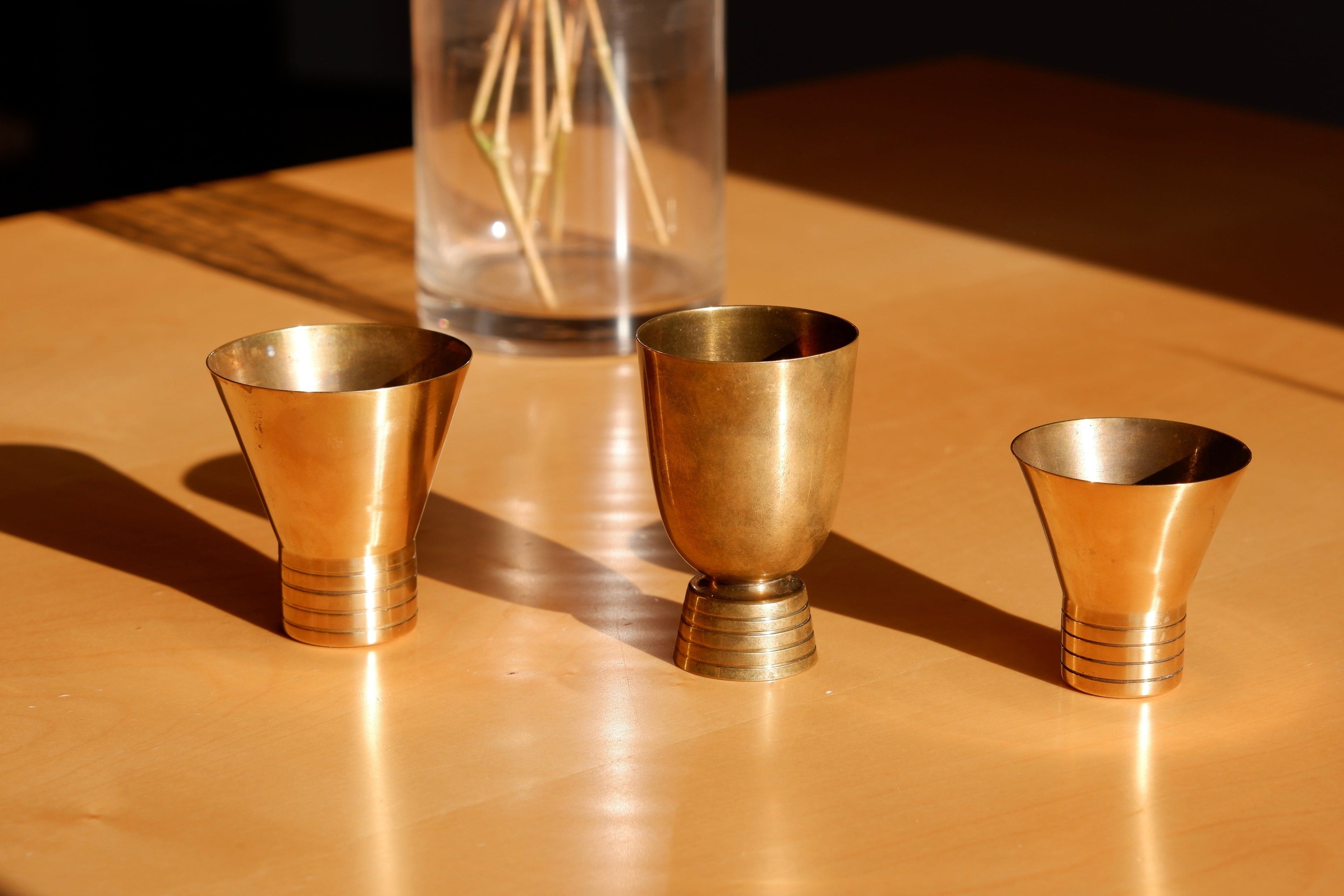 Set of three brass cups designed by Paavo Tynell for TAITO circa 1940