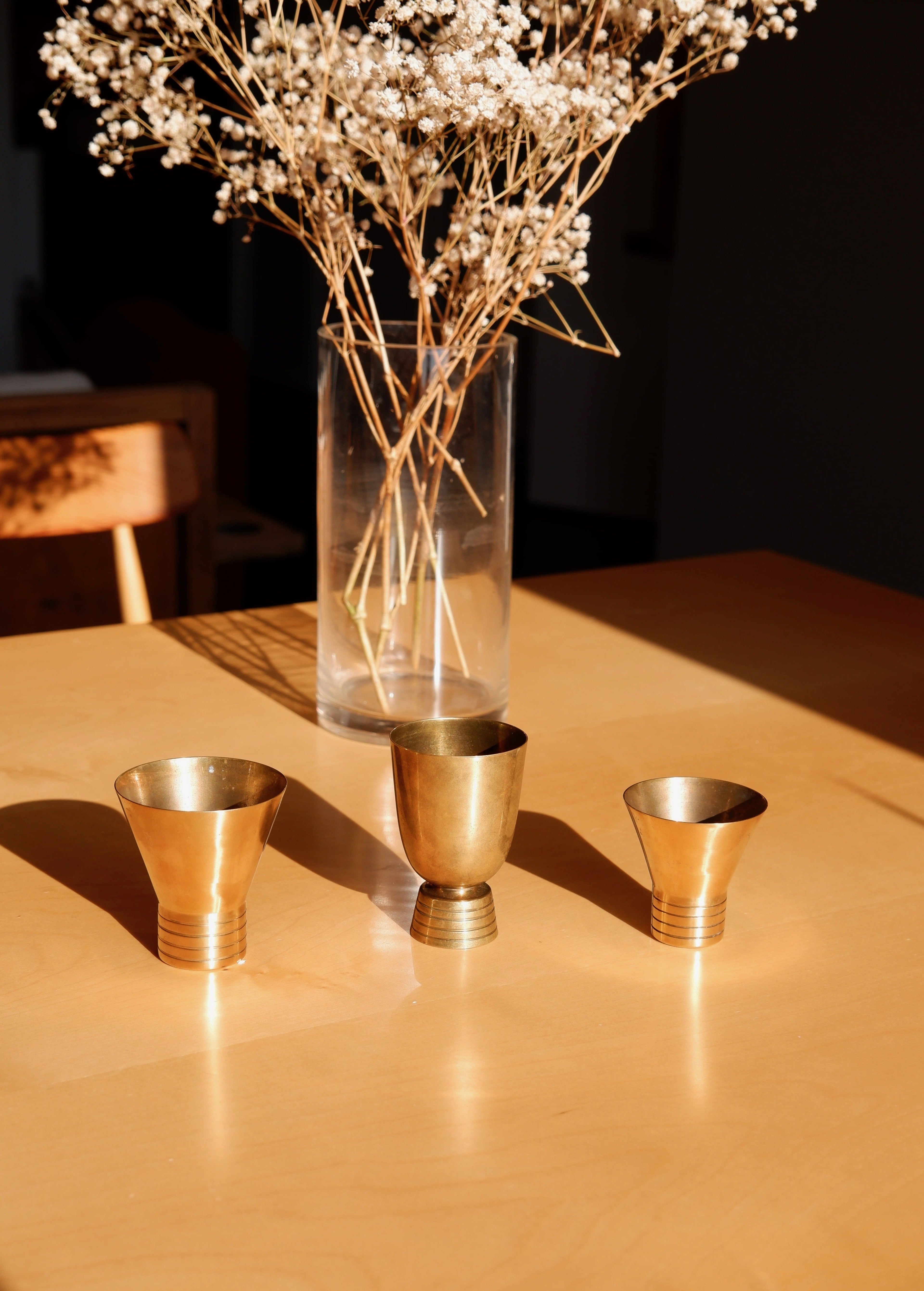 Set of three brass cups designed by Paavo Tynell for TAITO circa 1940